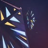 Geometric patterns with illuminated triangular shapes in yellow, blue, and red against a dark background.